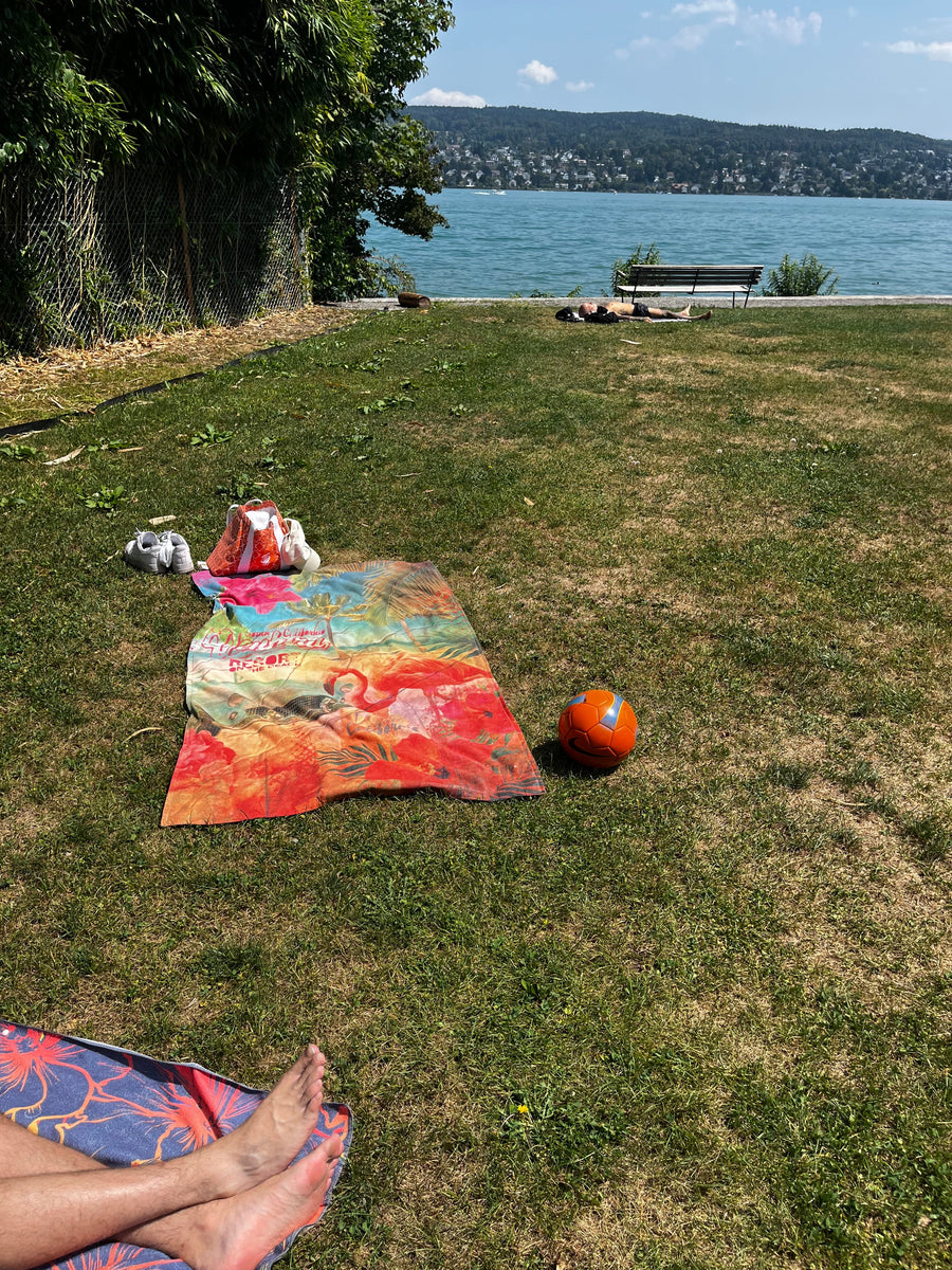 Feet on a towel by the lake